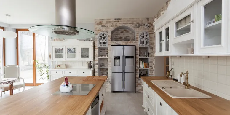 Modern kitchen with white cabinets and stainless steel appliances